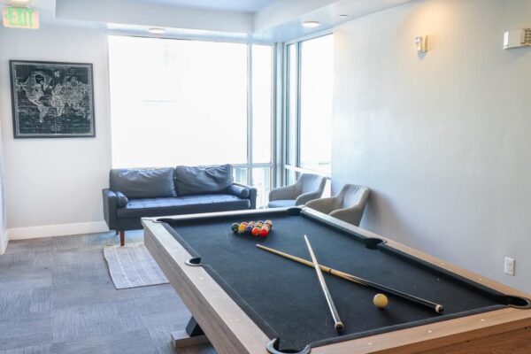 Promenade apartment community game room with pool table